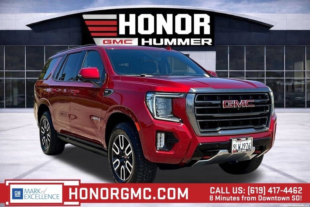 2024 GMC Yukon AT4 in Volcanic Red Tintcoat — front three-quarter view